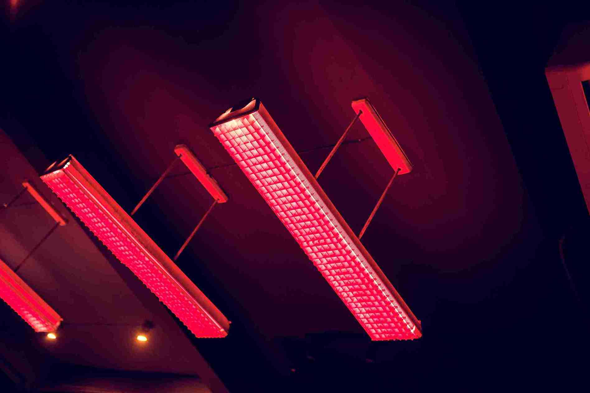Red light therapy panels used for hair loss treatment, emitting therapeutic red wavelengths.