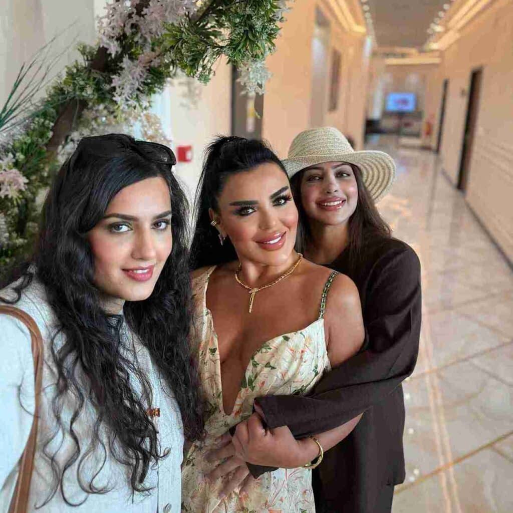 Three smiling women taking a selfie after rhinoplasty.